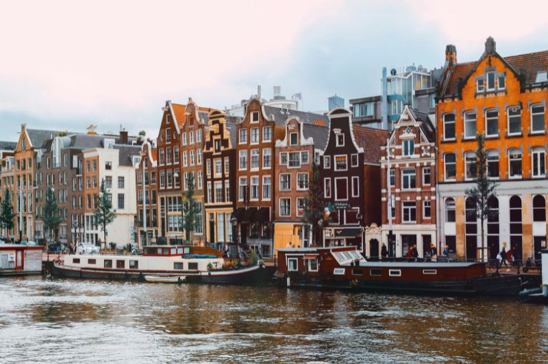 Vintage photo of an amsterdam canal with historic buildings.