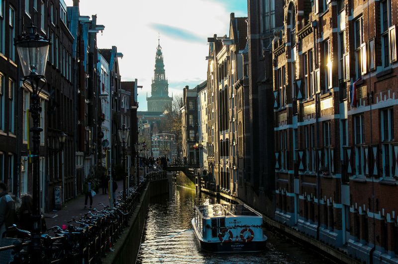 Amsterdam canal lined with traditional houses along the water.