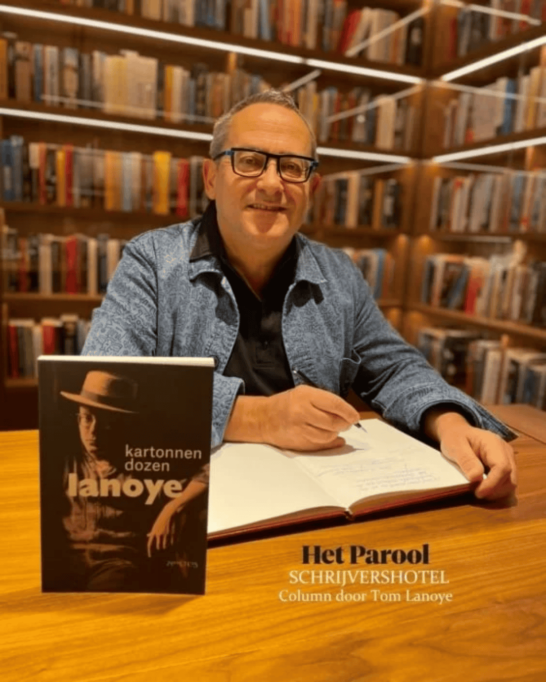 Author tom lanoye signing his book kartonnen dozen at the ambassade hotel for the hotel library.