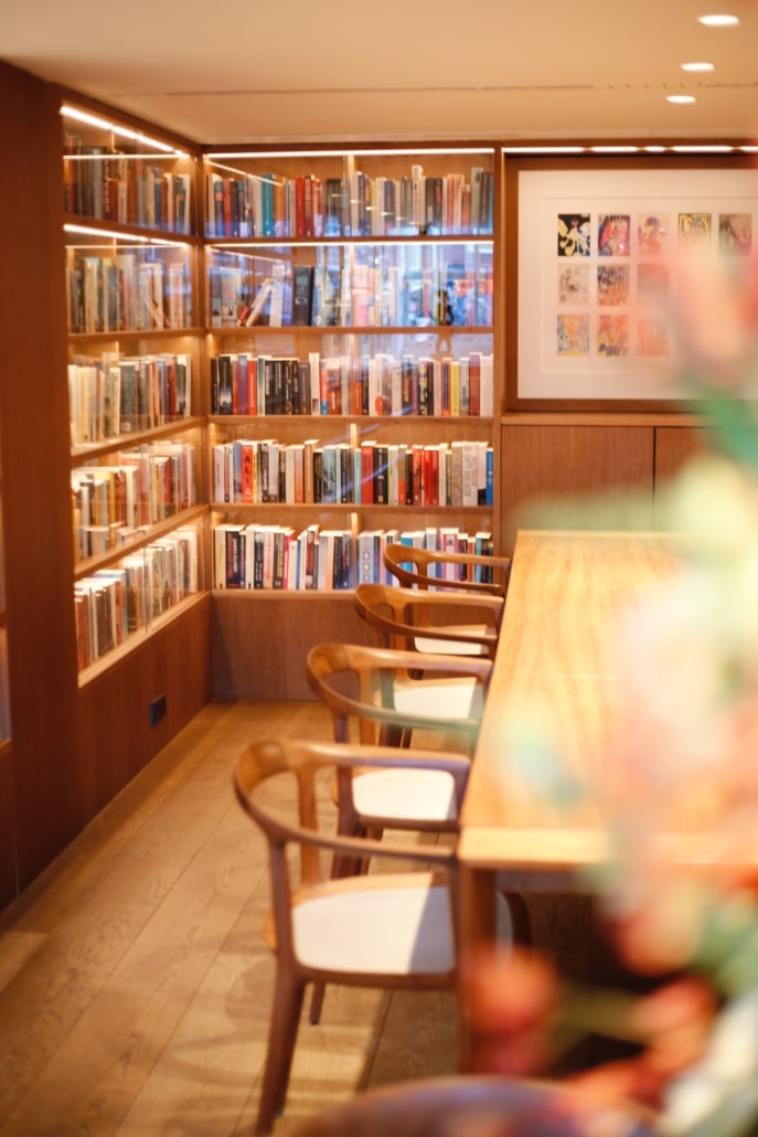 The library lounge at the ambassade hotel with books, art, and elegant seating.