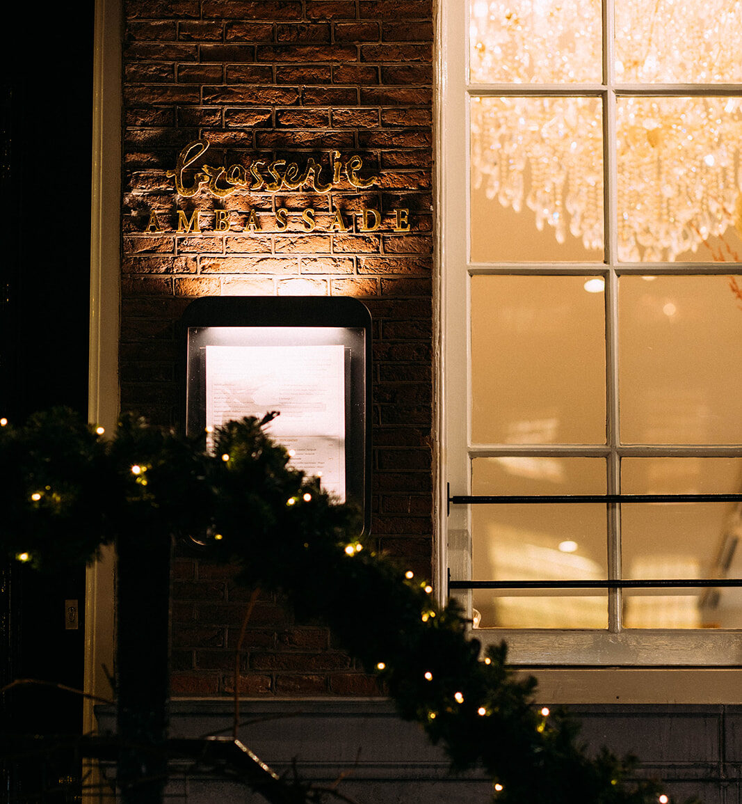 Brasserie ambassade in amsterdam beautifully illuminated with christmas lights by the canals