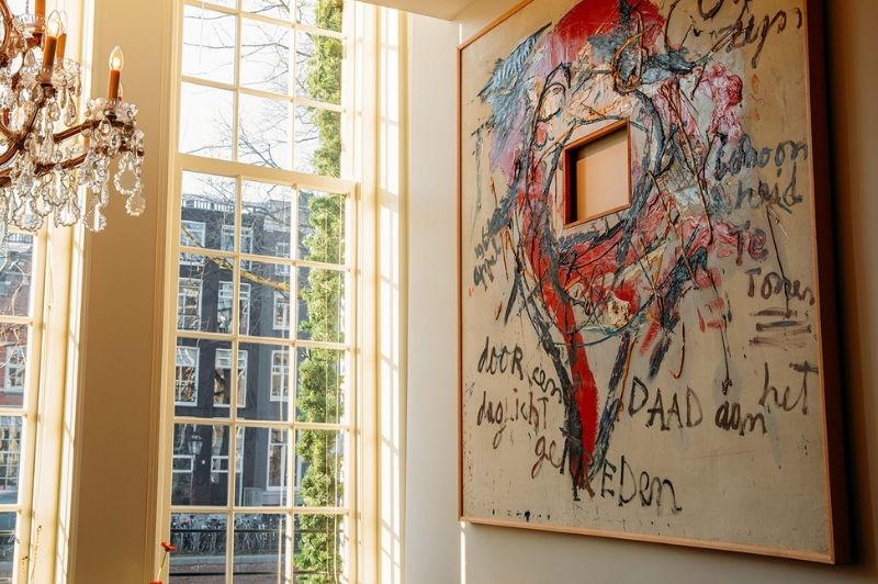 Œuvre de Karel Appel exposée à la Brasserie Ambassade à Amsterdam, mettant en avant des couleurs vives et un style expressif.