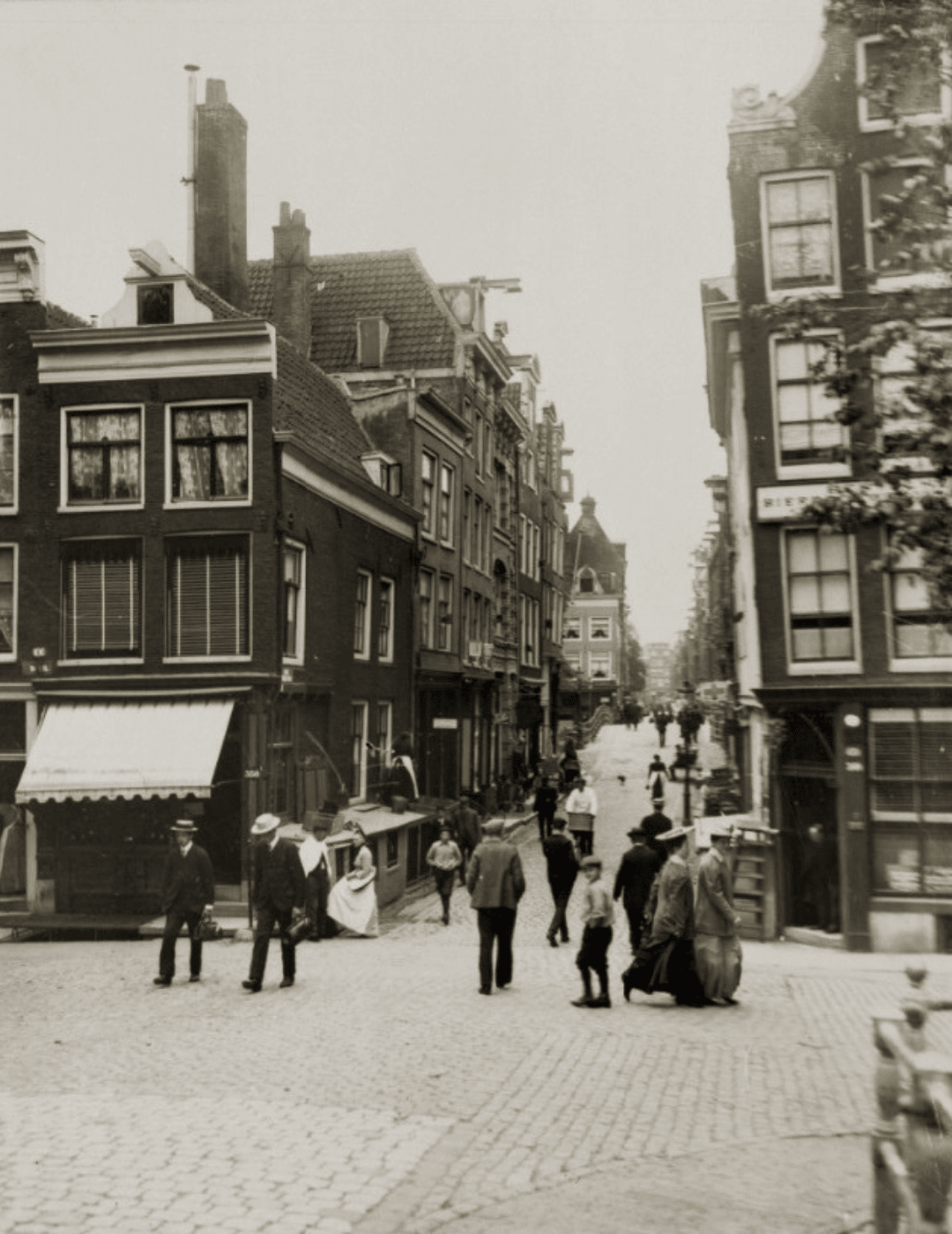 Photo vintage de l'Oude Spiegelstraat à Amsterdam, montrant des bâtiments historiques et une scène de rue.
