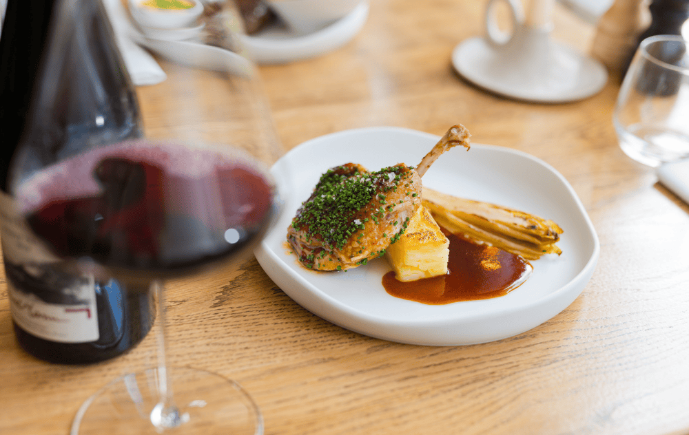 Plate of confit de canard served at brasserie ambassade.