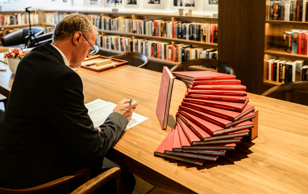 The ambassade hotel’s librarian organizing books in the library bar.