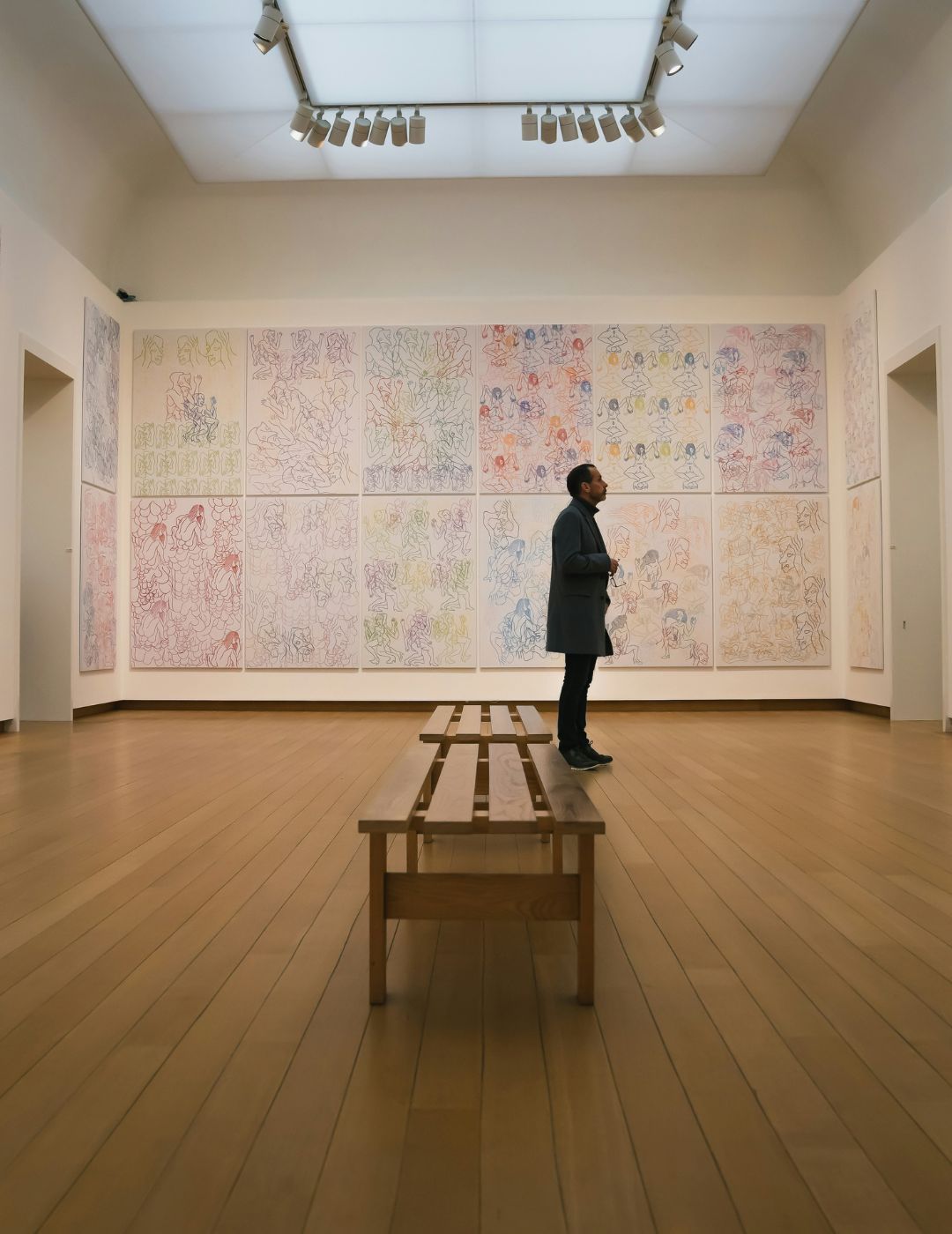 Intérieur du Stedelijk Museum à Amsterdam avec un visiteur observant de l’art moderne.