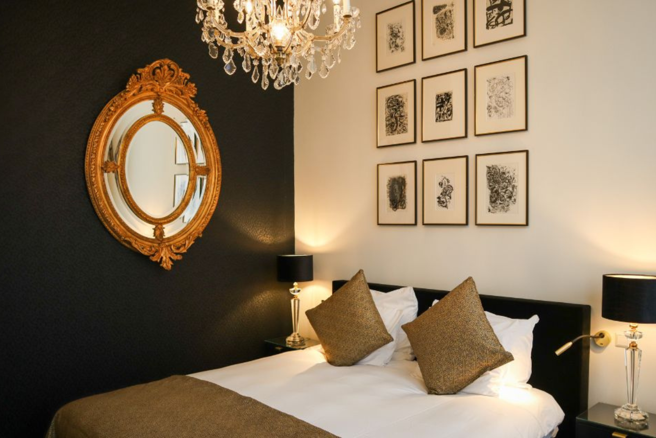 Canal view deluxe room featuring elegant black and gold accents at the ambassade hotel.