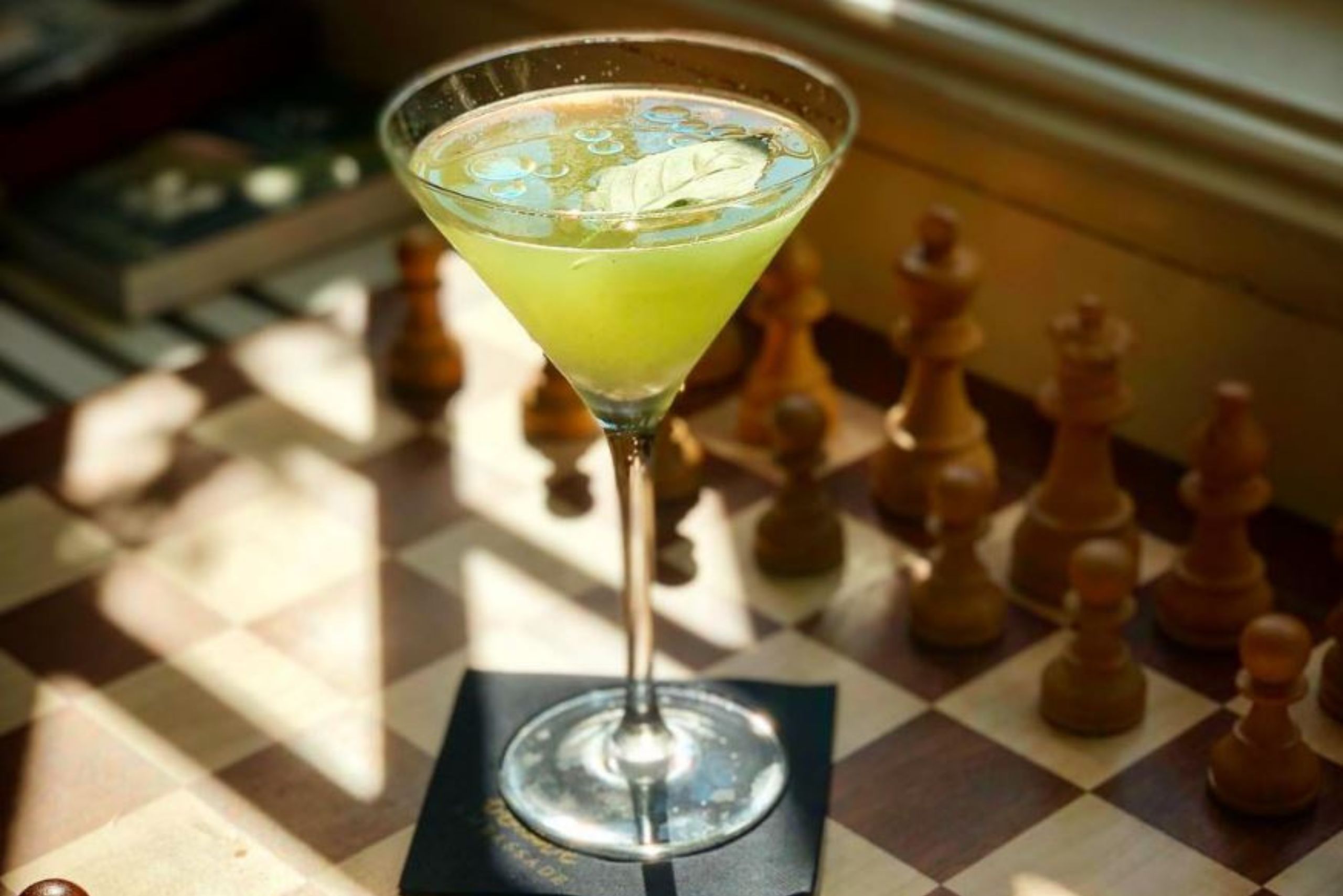 Basil smash cocktail served at the library bar in the ambassade hotel, offering a refreshing blend of gin and basil.