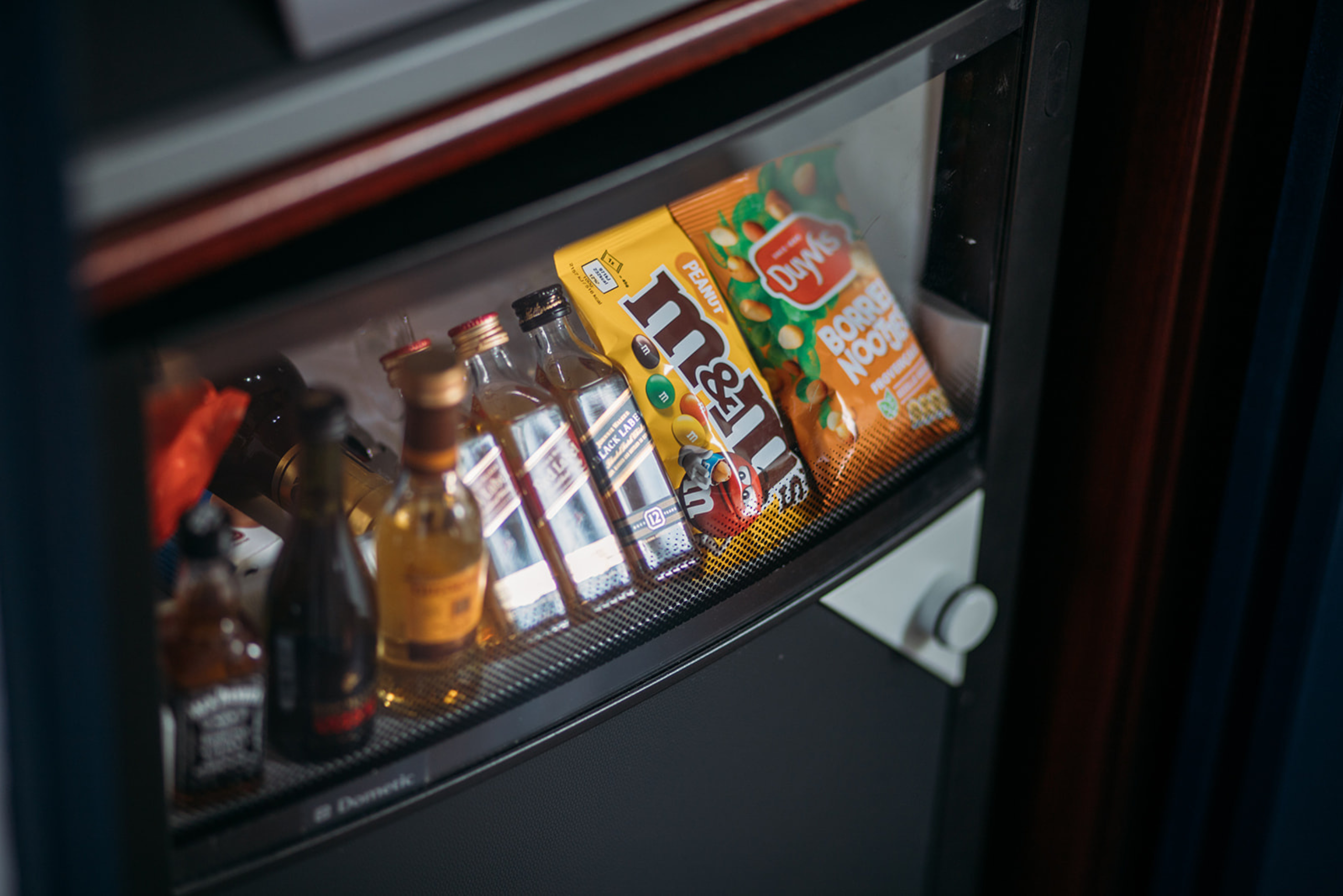 Mini bar at the ambassade hotel with premium drinks, sweet and savory snacks.