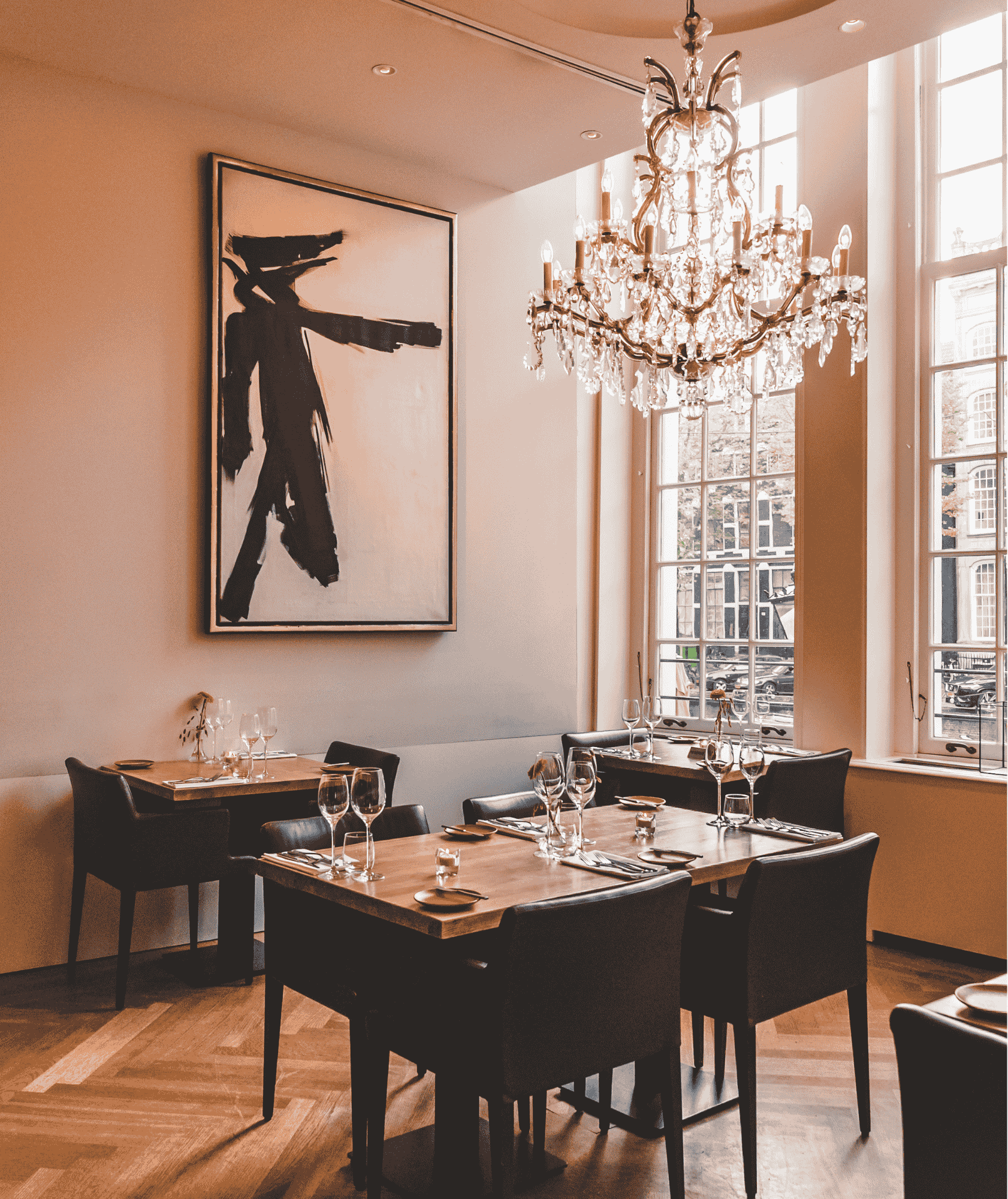 Elegant dining setup at brasserie ambassade with views of the herengracht canal in amsterdam.