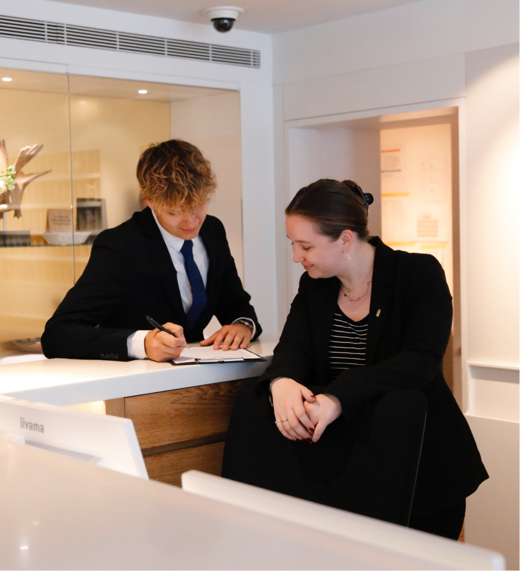 Zwei Empfangskolleg*innen im Ambassade Hotel.